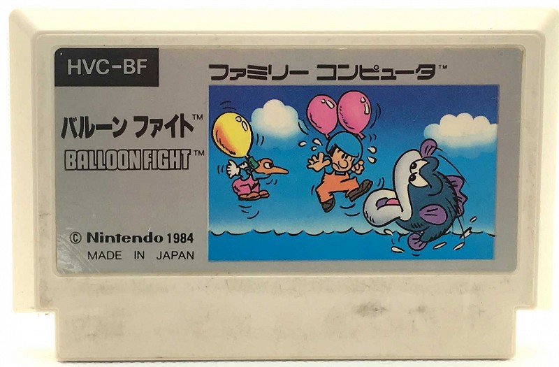 Photo of Balloon Fight for the Nintendo Famicom. White cartridge with a few dark blemishes and scratches on it.